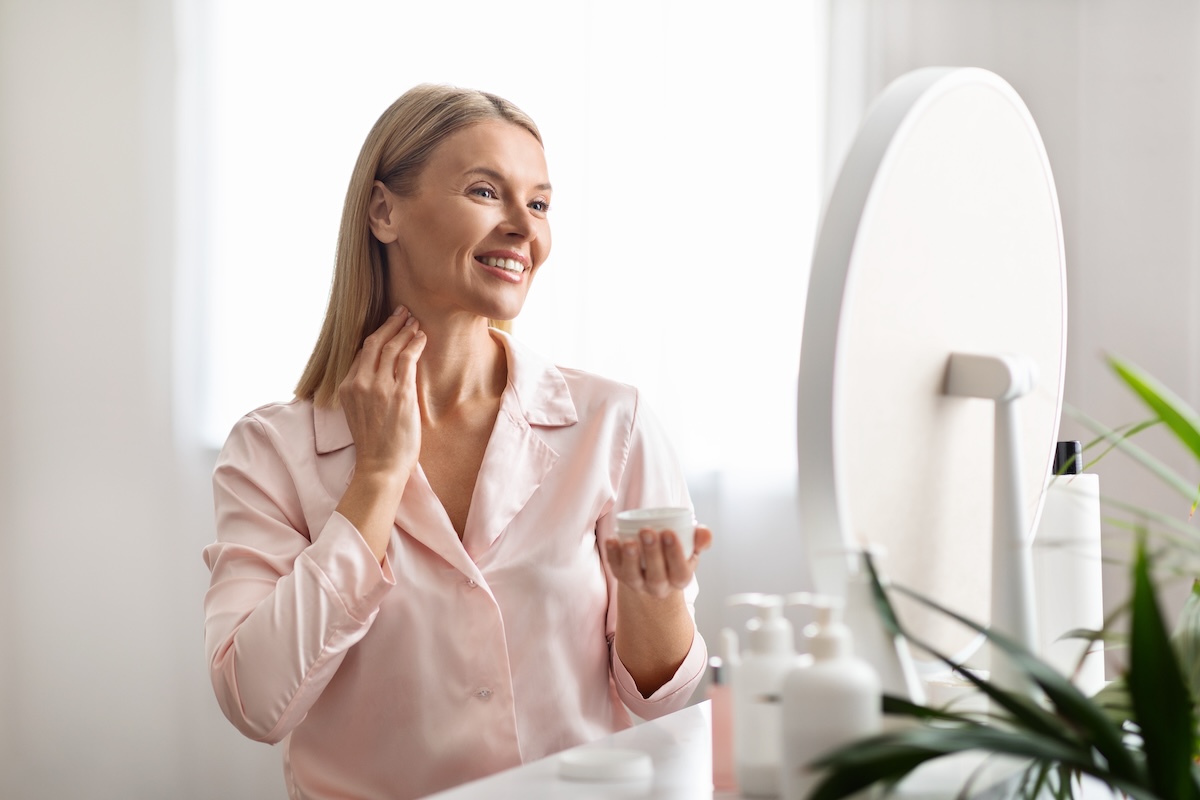 Middle-aged woman applying moisturiser, representing real-life skincare routines and confidence in ageing