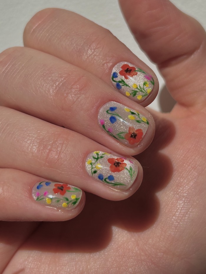 Champagne cat eye nails with floral design on top
