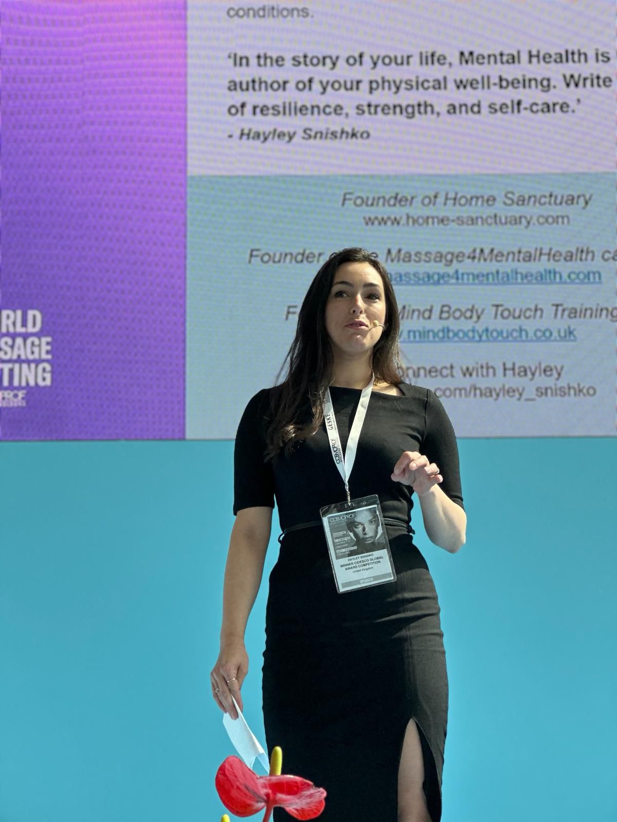 Hayley Snishko presenting on stage at a Cidesco beauty industry event