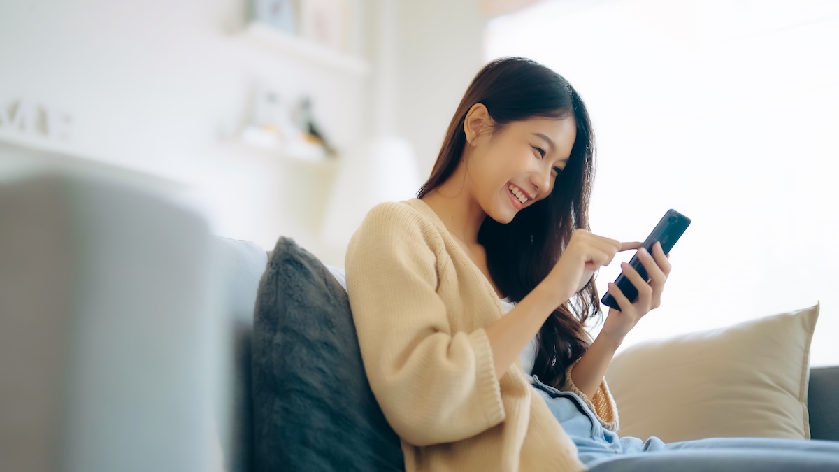 Young woman engaging with social media on her phone, similar vibe to lead image