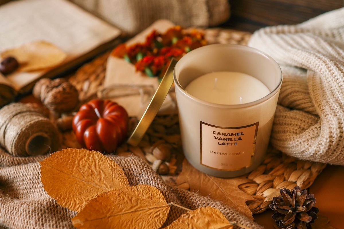 Autumnal scented candle representing seasonal fragrance and wellness trend 2025