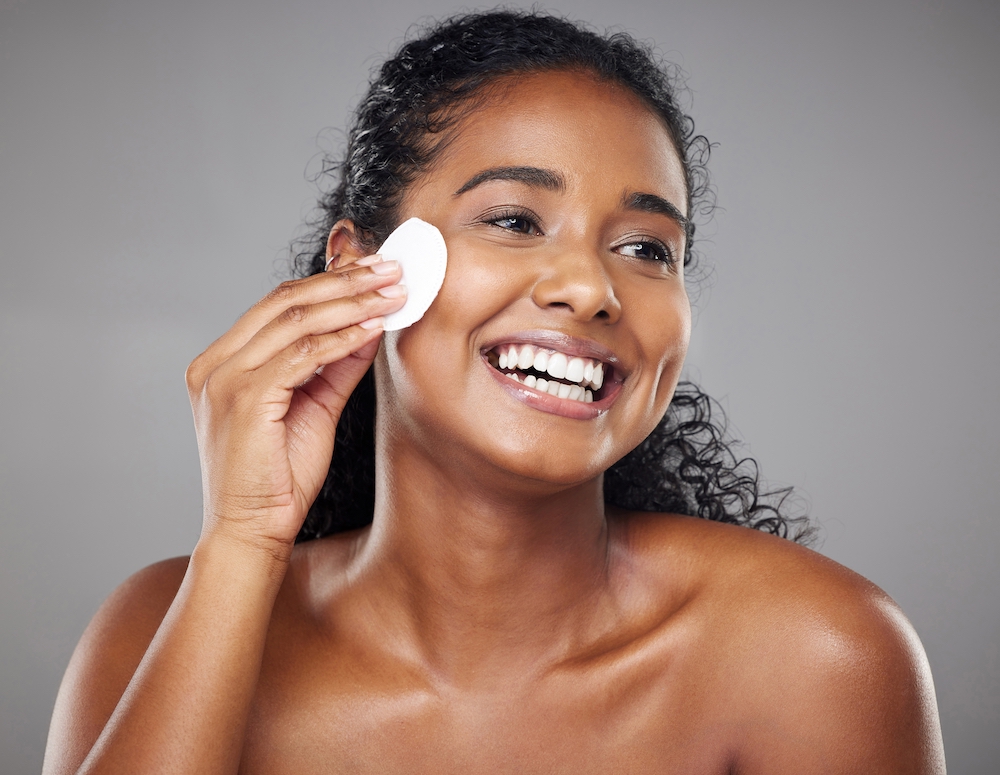 Woman cleansing and exfoliating skin 