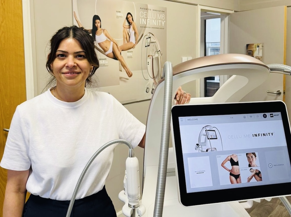 Shweta Kaushik Nagpal, founder of Harmony Skin and Beauty Therapy, standing next to an LPG device