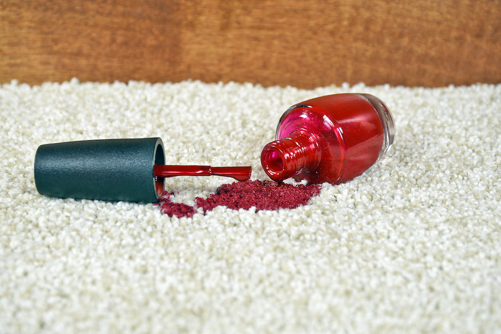 Nail polish spilled on a rug during a home beauty treatment, illustrating the importance of beauty insurance for mobile therapists