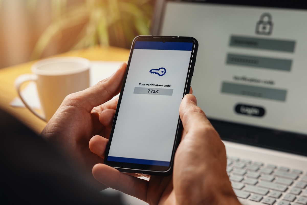 Person using two-factor authentication on a smartphone to securely log in, illustrating best practices for salon and spa cybersecurity
