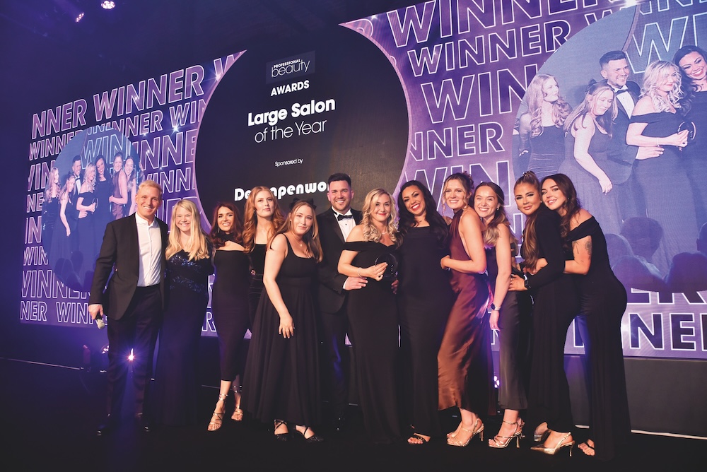 Anna and Dan Inglis with the Elegant Touch Beauty team on stage accepting their Professional Beauty Award