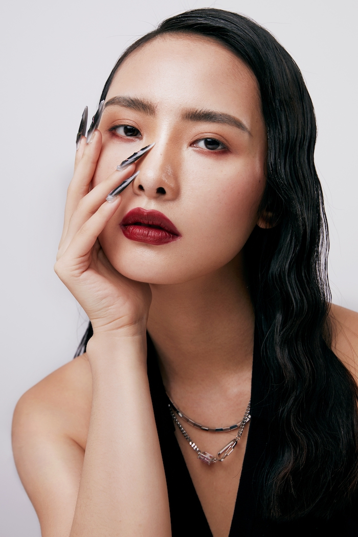 Model with soft matte skin and deep berry red lipstick