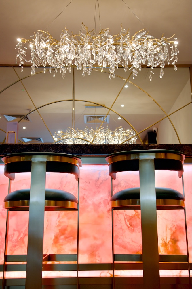 The pink onyx bar at Waldor Clinic London, a bespoke design feature creating a luxurious and welcoming client experience