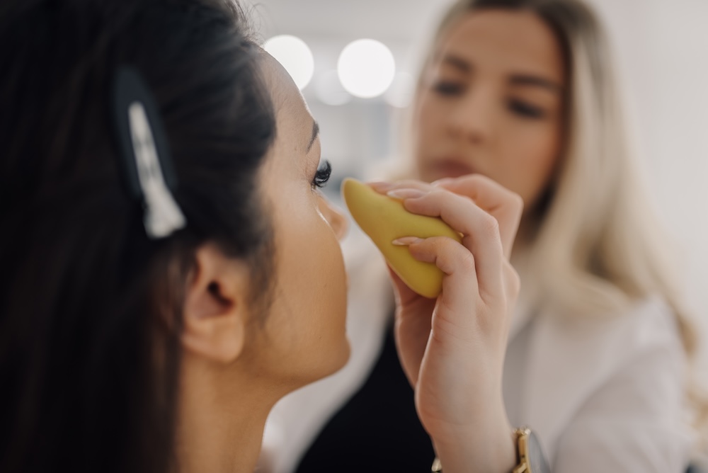 Makeup artist applying foundation to a client during a professional makeup appointment