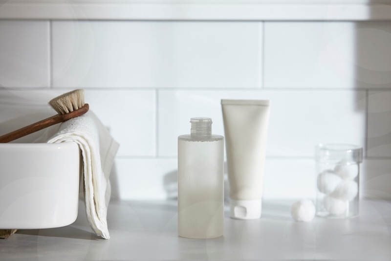 Bathroom counter with hard-to-recycle beauty packaging and personal care waste, highlighting recycling challenges for the 2026 Great British Beauty Clean Up