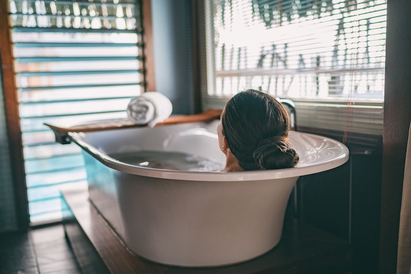 Woman relaxing in a magnesium salt bath as part of a wellbeing and skincare routine