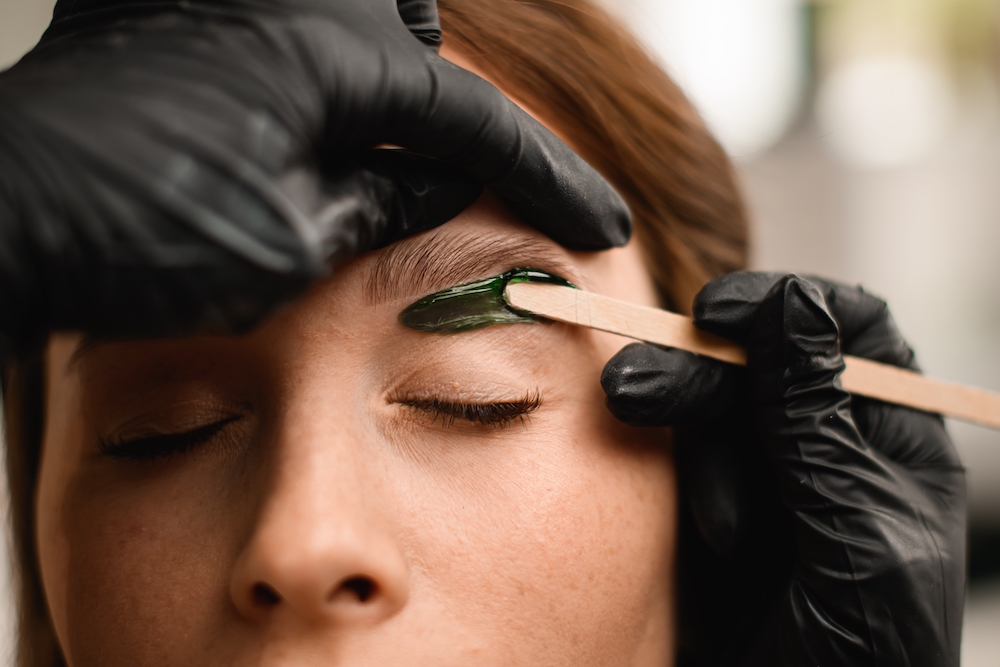 Woman having a professional eyebrow wax