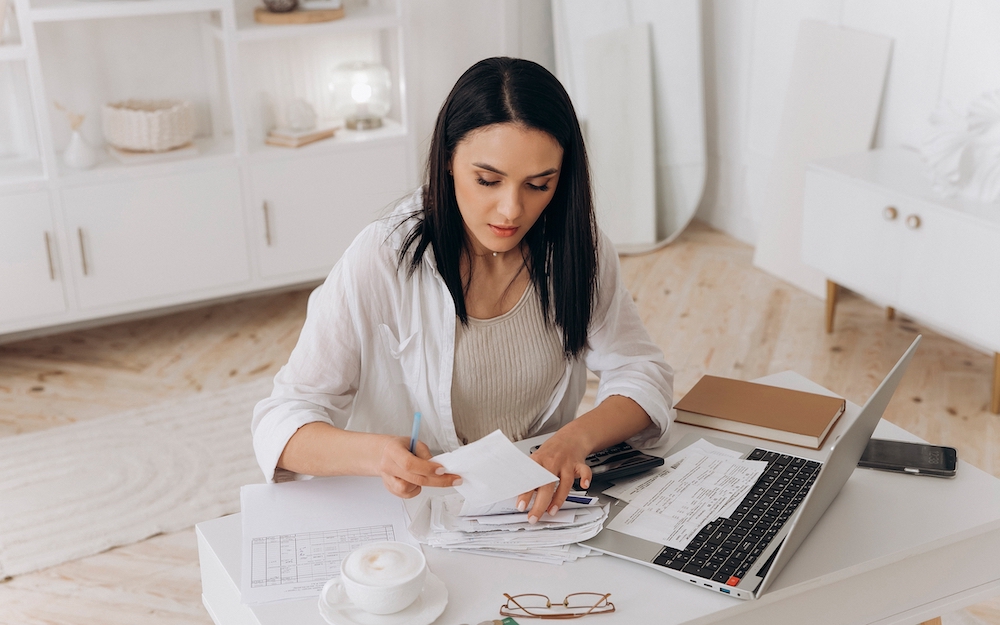 Woman looking through bank statements and finances