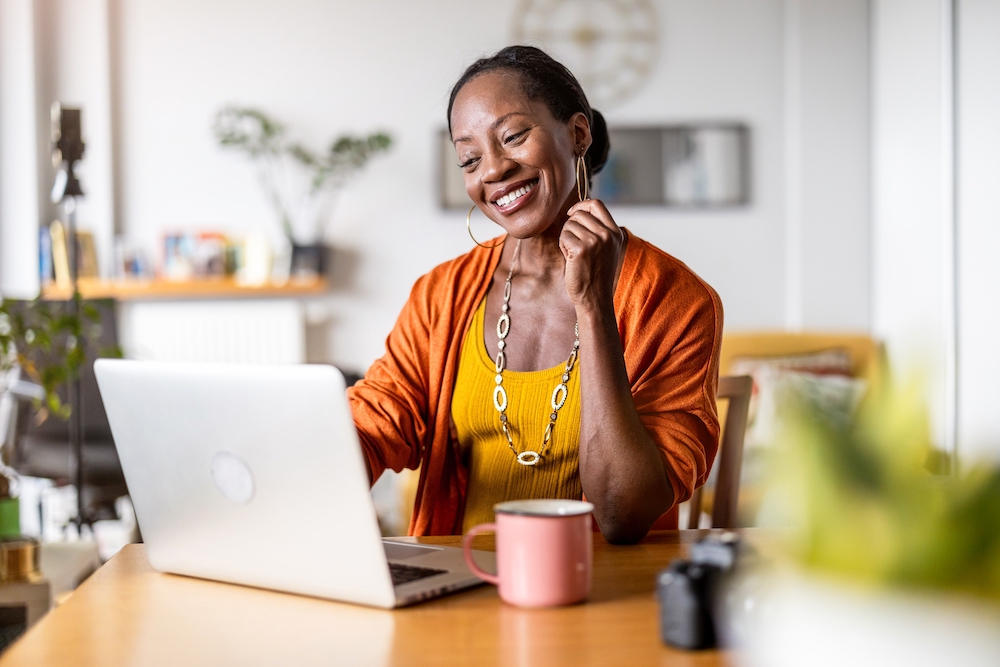 Woman sitting at home working on her laptop