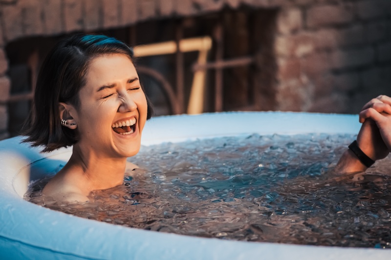 Woman immersing in a cold plunge pool during contrast therapy to boost recovery, circulation, and mental clarity