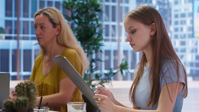 Gen Z salon employee in a one-to-one meeting with their manager