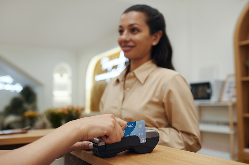 Client paying for a treatment at the reception desk of a beauty salon