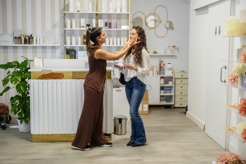 Beauty therapist guiding a client through a retail journey