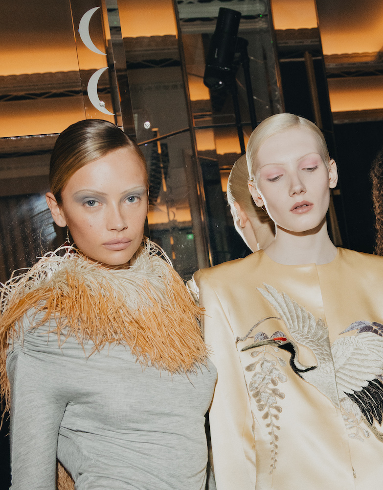 Two models at Connor Ives' LFW show, left with soft grey eyeshadow and right with pale pink eyeshaow
