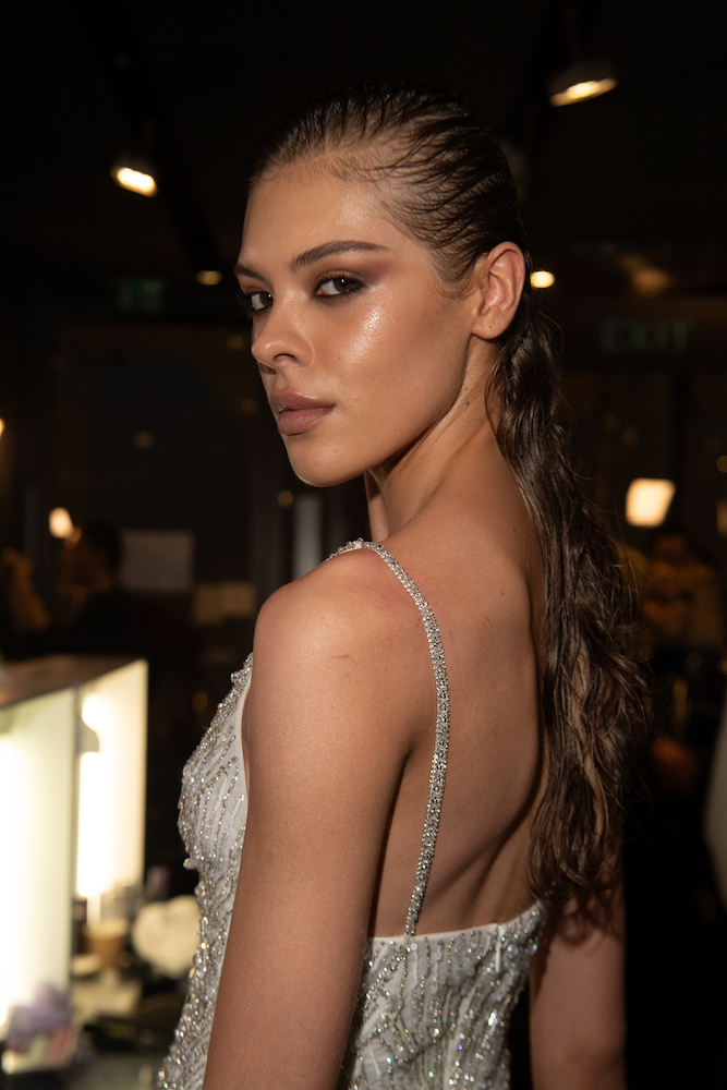 Model with glowing complexion and smoky eye makeup walking for Julien Macdonald at LFW 