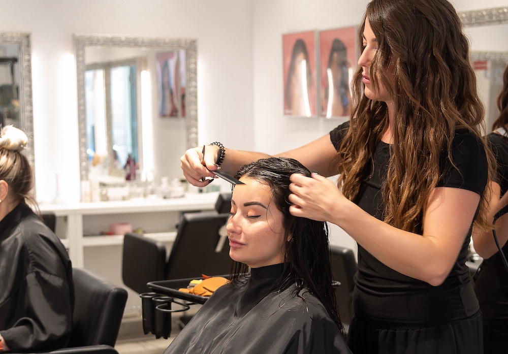 Female hairdresser working in a salon, cutting a clients hair 