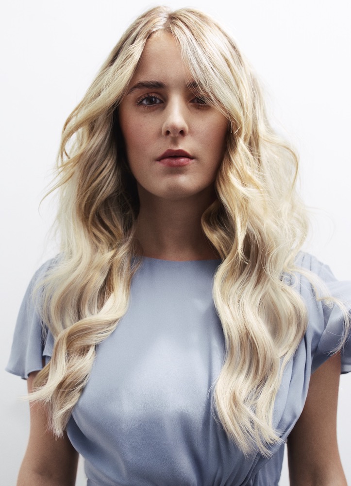 Model facing the camera with buttercream blonde hair