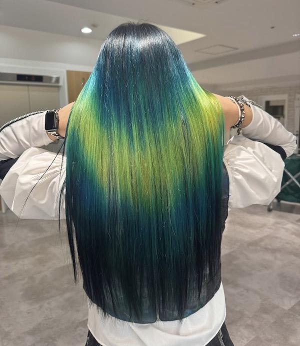 The back of a woman's hair, in vivid blue and teal tones, featuring the shine line colour technique