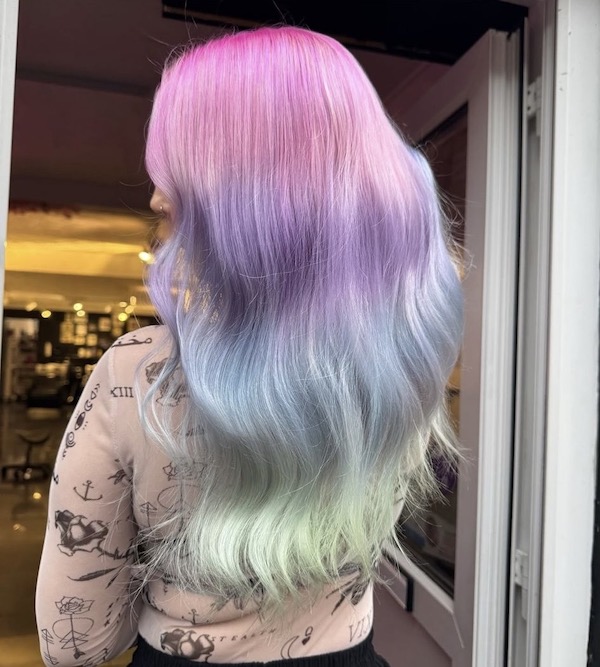 Pastel mermaid ombre hair with pinks, lilacs and blues, styled in soft waves