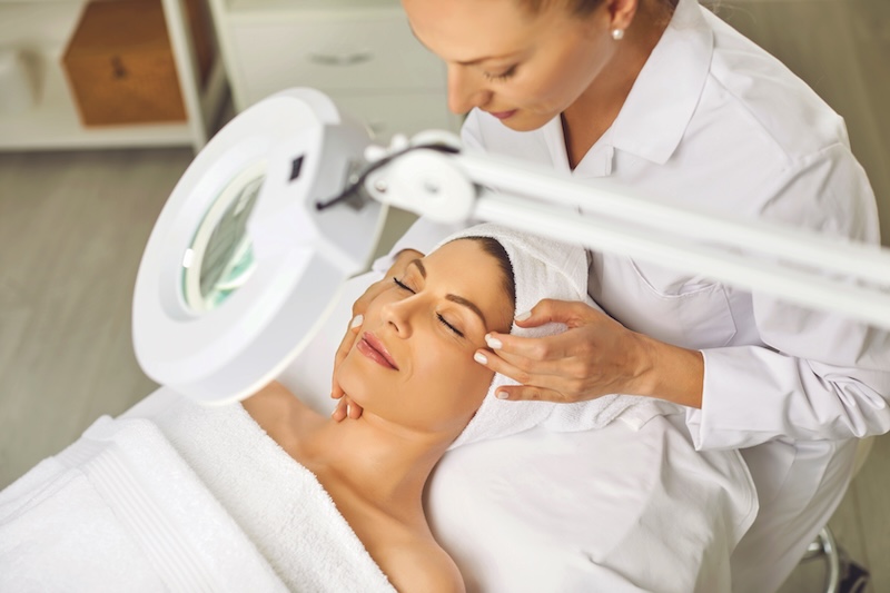 Skin therapist examining a client’s skin during a professional consultation to assess barrier health and treatment needs