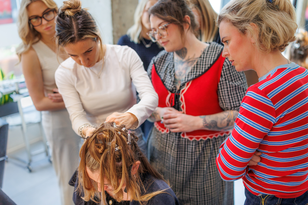 Hair stylists receiving training and education on BHBD hair extensions