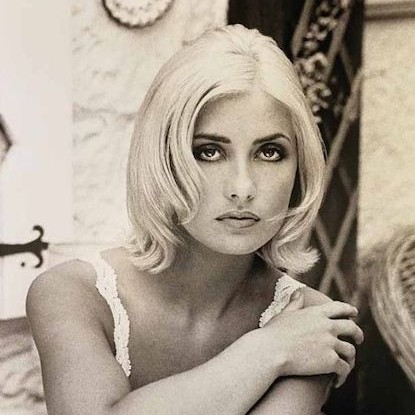 Black and white image of model with short platinum blonde hair