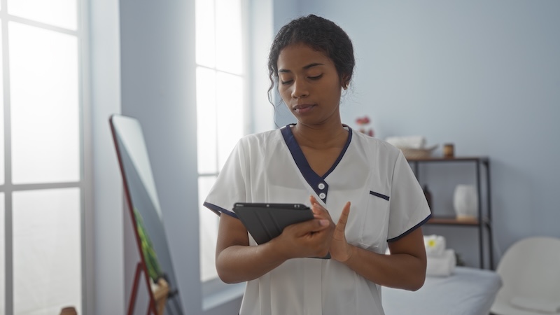 Massage therapist working alone in a home-based or mobile treatment space, illustrating solo practice in the wellness industry