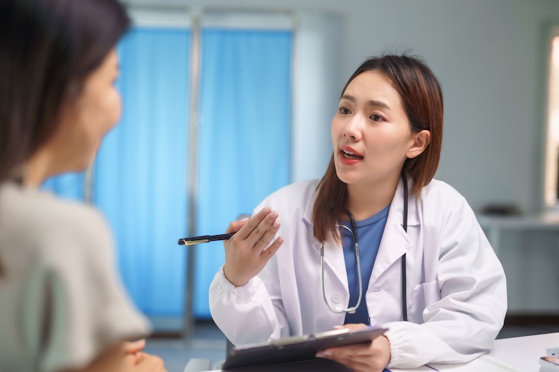 Woman attending a medical consultation with a doctor before receiving IV therapy treatment.