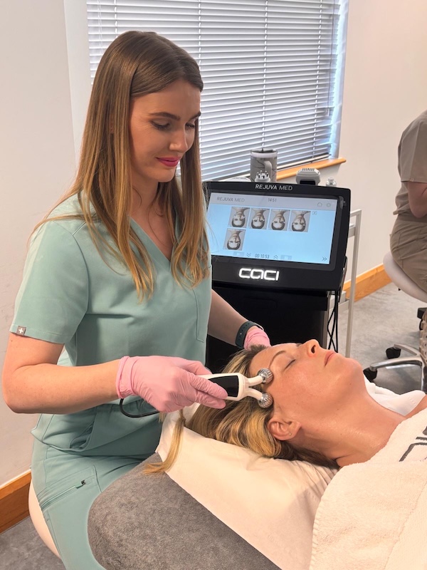 Larissa Warren performing a facial treatment using the CACI Rejuva Med system on a client, demonstrating UV-adapted skin treatment techniques