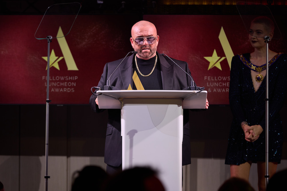Fellowship President, Simon Shaw, on stage