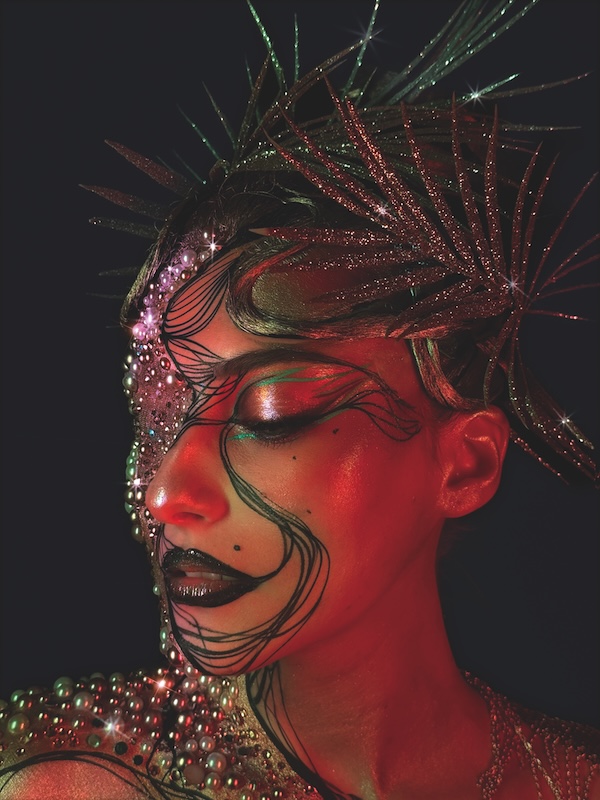 Model wearing an editorial creative makeup look designed by Glow Up finalist James Mac.