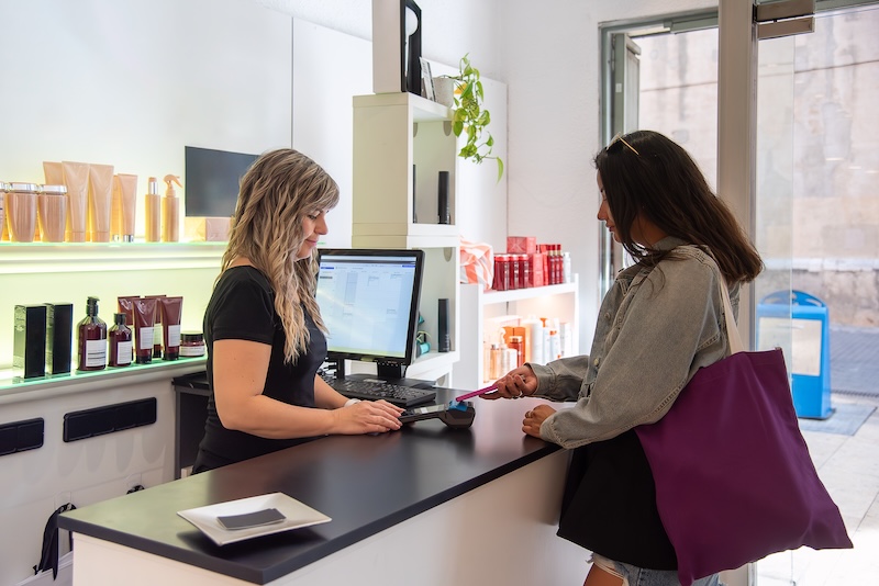 Client buying retail beauty products in a salon