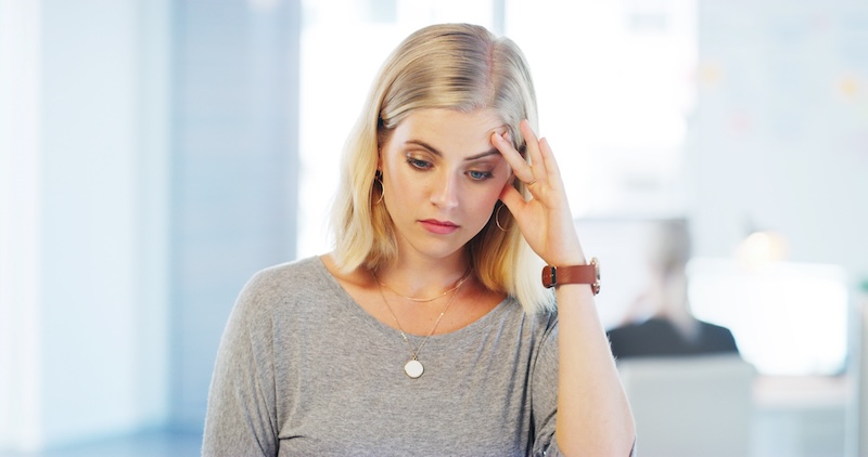 Woman looking overwhelmed and emotionally exhausted