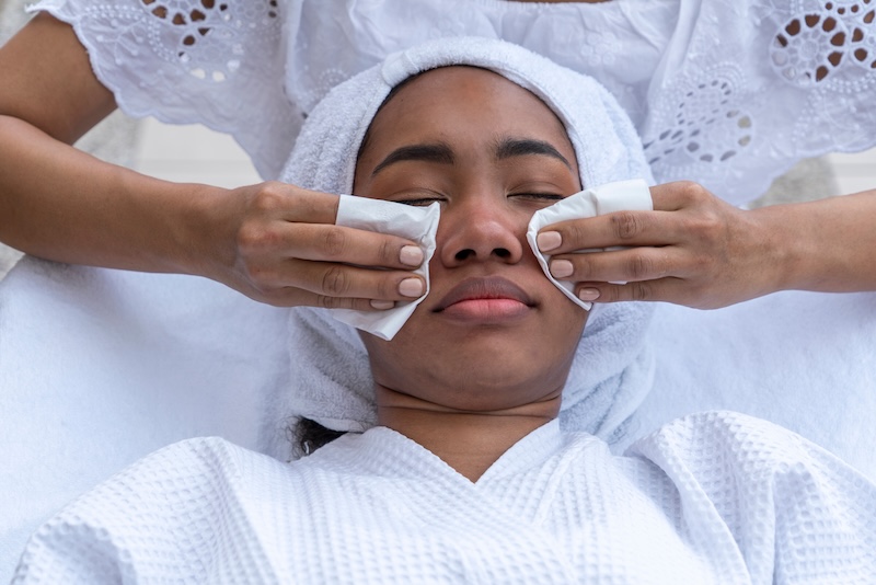 Pregnant client receiving a pregnancy-safe facial treatment from a skincare therapist