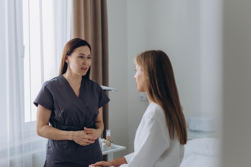 Beauty therapist talking to a client during a consultation to deliver excellent customer service