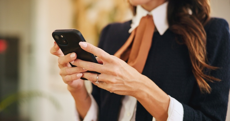 Woman booking a beauty appointment through an app on her phone