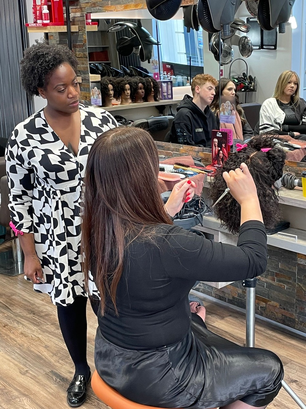 Naomi Brooks teaching a hairdressing masterclass focussing on Afro hair