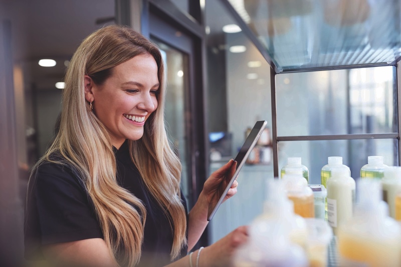 Salon owner using AI to manage stock in a beauty salon