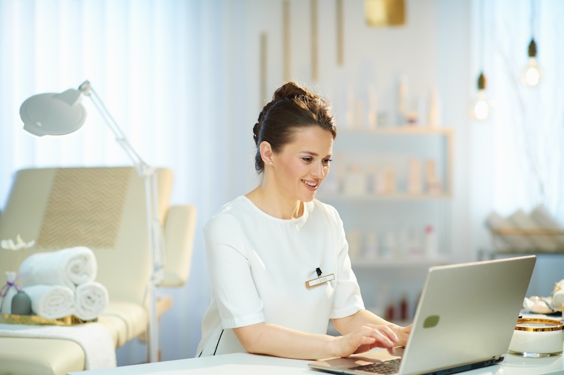 Spa employee using a laptop for business administration