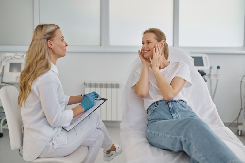 Aesthetic consultation between a practitioner and patient in a clinic, discussing potential cosmetic treatment outcomes