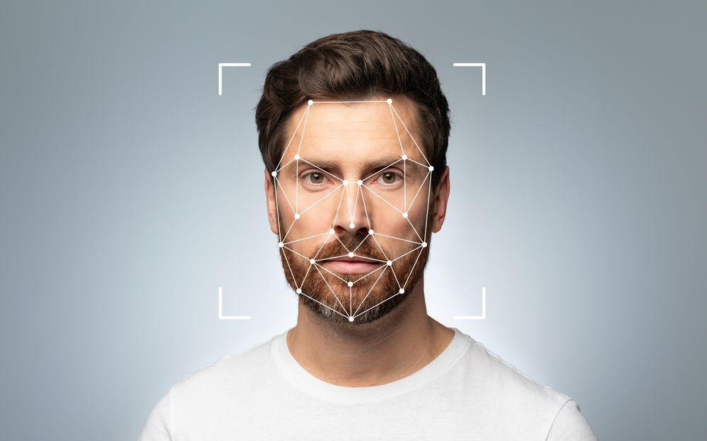 Man with facial analysis markers overlaid on his face, illustrating AI-powered facial mapping and assessment.