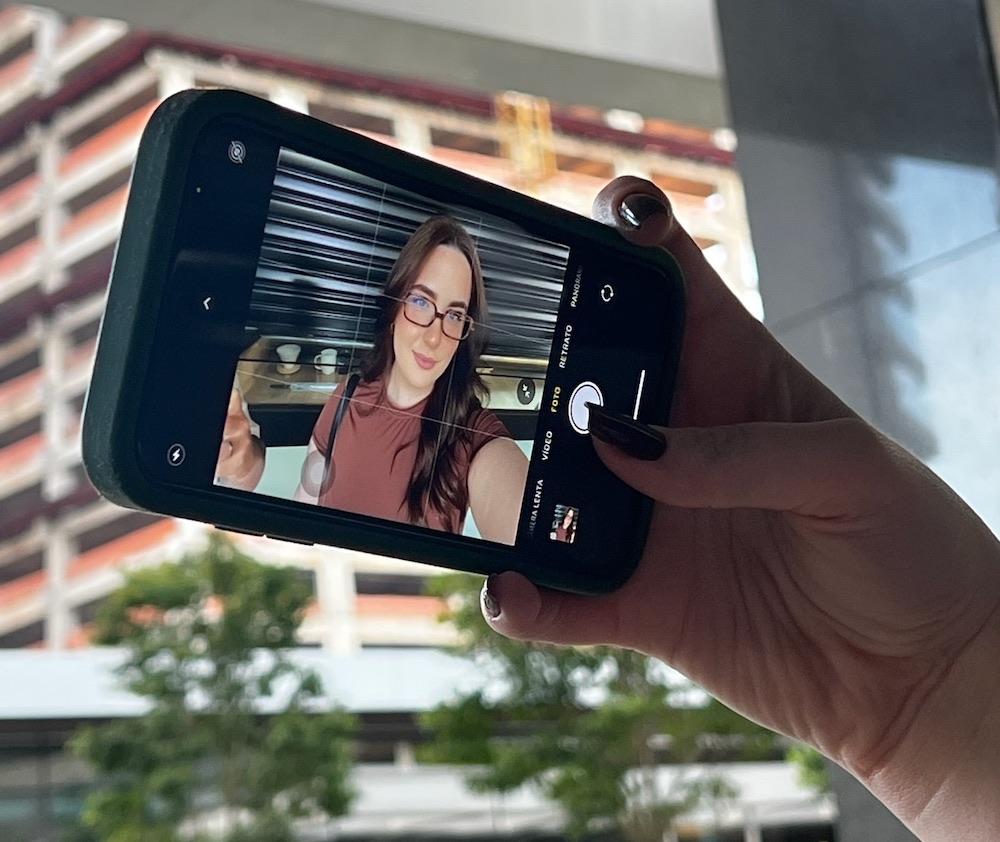 Influencer taking a selfie on her phone