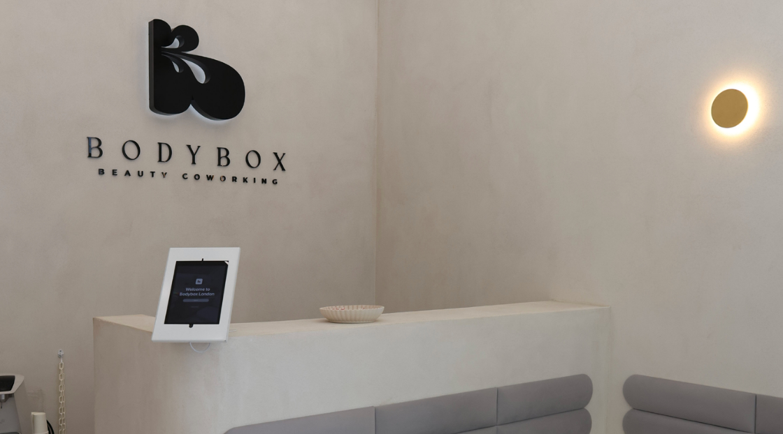 Bodybox Beauty Coworking reception area with branded wall signage, reception desk and seating.